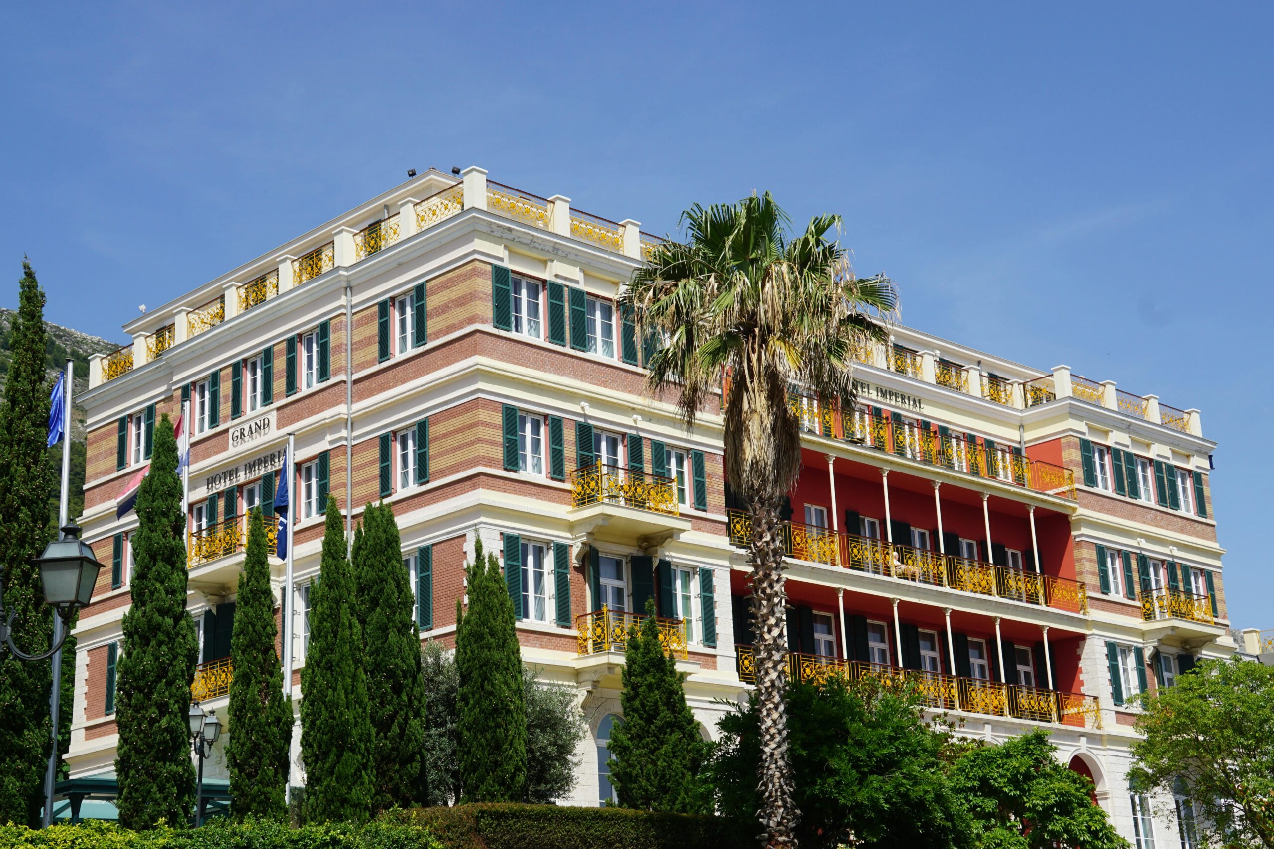 Stunning exterior view of the Hilton Imperial Hotel with vibrant balconies in Dubrovnik.